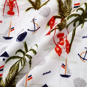 Close-up detail of soft beach shirt fabric featuring nautical lobster and palm tree prints