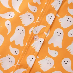 Close-up of orange Hawaiian shirt featuring cute ghost pattern and button detail