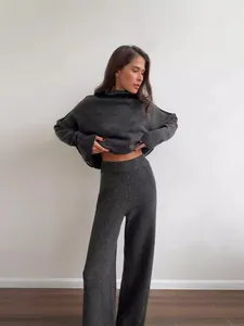 Elegant grey two-piece knitted set with turtleneck loose sweater and wide-leg trousers