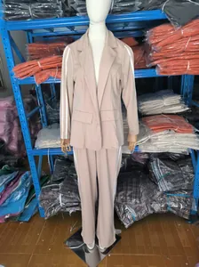 Full set detail of beige lapel blazer and matching wide-leg trousers on mannequin