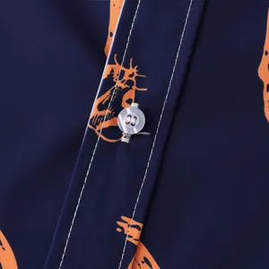 Detail close-up showing stitching and button on navy blue Halloween printed shirt