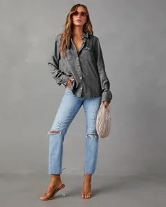 Stylish women's casual long-sleeve gray denim shirt paired with distressed blue jeans