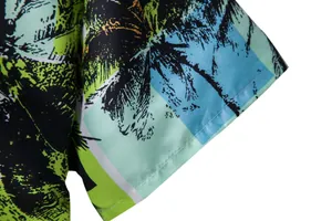Detailed macro shot of the palm tree print and stitching on Hawaiian shirt sleeve