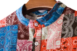 Detail of the stand-up collar and vibrant patchwork paisley print on a cotton linen shirt