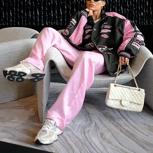 Detail view of a women's racing jacket with pink and black patchwork design