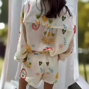 Detail view of colorful bohemian pattern on off-white summer shirt and shorts set