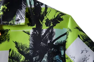 Macro detail of men's tropical palm tree print Hawaiian shirt showing fabric texture