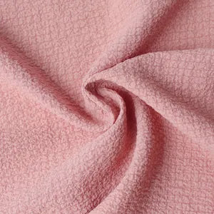 Macro detail of breathable pink seersucker fabric texture for men's summer shirt