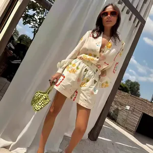 Elegant summer two-piece set featuring a V-neck printed shirt and matching shorts