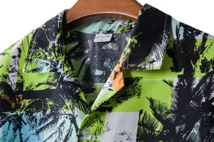 Detailed view of the collar and vibrant palm tree print on a tropical men's Hawaiian shirt
