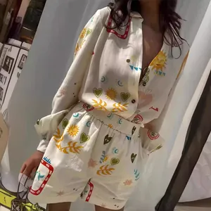 Detail view of summer V-neck shirt and shorts set with colorful sun and heart prints