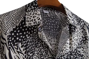 Macro detail shot of a men's casual shirt featuring black and white animal prints