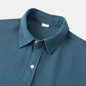 Close-up of men's teal casual shirt collar showing waffle texture and size S tag.