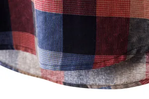 Close-up detail of a men's plaid linen shirt showing curved hem and fabric texture