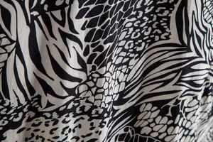 Detailed macro view of black and white animal print fabric for men's casual floral shirt