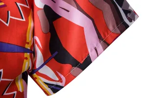 Close-up of neat sleeve stitching on a red ethnic print Hawaii short sleeve shirt