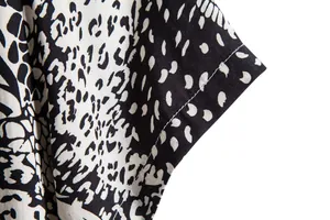 Detailed macro shot of black and white leopard print casual shirt showing seams
