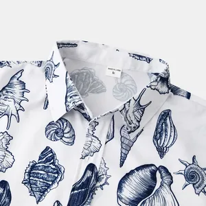 Detailed macro view of the collar and navy seashell print on a white men's beach shirt