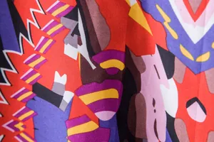 Detailed macro view of colorful ethnic pattern print on soft Hawaiian shirt fabric.