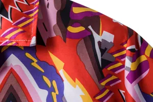 Close-up detail of vibrant ethnic geometric print on a men's Hawaiian shirt.