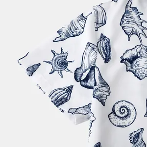 Macro detail of the nautical blue seashell pattern printed on white beach shirt fabric