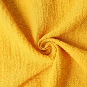 Close-up of yellow seersucker fabric texture for men's summer short sleeve shirt