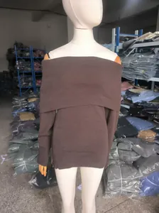 Close-up of a brown off-the-shoulder knitted sweater displayed on a white mannequin