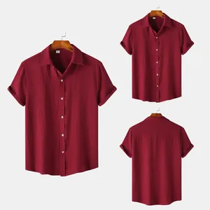 Detailed view of maroon men's short sleeve shirt with textured fabric and white buttons