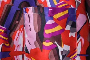 Close-up of pocket on men's ethnic print Hawaiian shirt with vibrant abstract pattern.