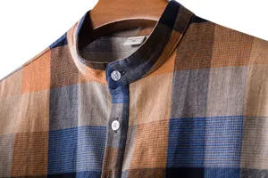 Close-up detail of men's casual plaid linen shirt featuring a classic band collar.