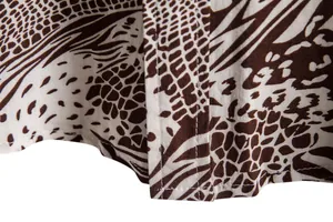 Macro detail of brown animal print fabric and precise stitching on men's casual shirt