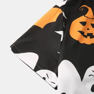 Detailed macro view of Halloween pumpkin and ghost pattern on black Hawaiian shirt sleeve