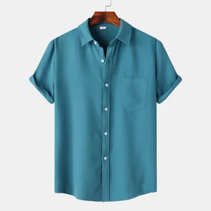 Macro view of teal waffle-textured fabric on a men's short-sleeved casual shirt.