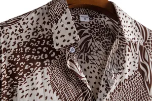 Close-up of men's casual short sleeve shirt featuring brown leopard print and classic collar
