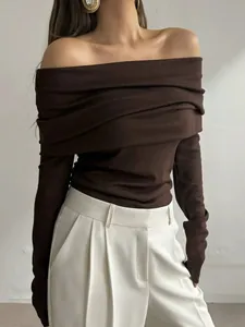 Detail view of a slim-fit dark brown off-the-shoulder long sleeve knit sweater