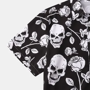 Macro close-up detail of white skull and rose floral print on black short sleeve shirt