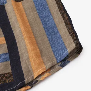 Close-up macro detail of men's striped shirt hem showing fabric texture and neat stitching