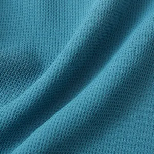 Macro view showing the breathable blue waffle weave texture of this men's casual shirt