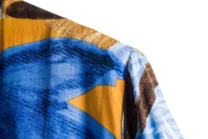 Close-up detail of the shoulder seam and colorful floral fabric on a men's casual shirt