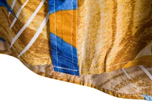 Macro detail showing high-quality stitching and floral print on men's casual short-sleeve shirt