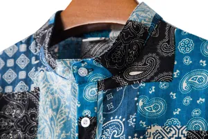 Macro view showing the fabric texture and collar of a men's blue paisley linen shirt