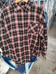 Close-up of pink and black plaid long sleeve shirt with button-down collar and chest pocket