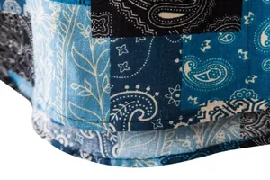 Detail shot of men's cotton linen shirt showing blue paisley patchwork and neat stitching