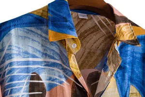 Detailed view of men's casual floral short-sleeved shirt collar with abstract print