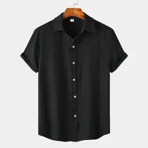 Detail view of men's black short-sleeved shirt with textured fabric and white buttons