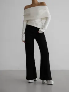 Slim fit off-shoulder long sleeve white knit sweater worn with black flare pants