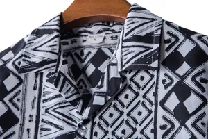 Close-up of tribal print on a black and white men's short-sleeve Hawaii shirt.