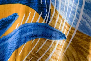 Close-up of vibrant floral pattern fabric with vertical white stripes on men's shirt