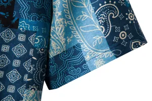 Close-up detail of a blue paisley patchwork linen fabric on a short sleeve shirt cuff