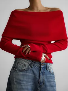 Close-up of vibrant red off-shoulder knit sweater with ribbed texture